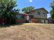 Street view of a two-story home with brick facade and well-maintained front yard at 12252 Elmendorf Pl, Denver, CO 80239