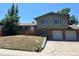 Charming two-story home with brick and siding, two car garage, and landscaped front yard at 12252 Elmendorf Pl, Denver, CO 80239