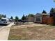 Exterior showcasing front yard with brick elements, two-car garage and partially xeriscaped yard at 12252 Elmendorf Pl, Denver, CO 80239