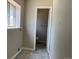 Hallway and bathroom featuring a window, door and damaged flooring at 12252 Elmendorf Pl, Denver, CO 80239