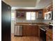 Updated kitchen featuring stainless steel appliances and wood cabinets with laminate countertops at 12252 Elmendorf Pl, Denver, CO 80239