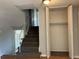 Carpeted staircase leads to the upper level with an open closet at the top of the landing at 12252 Elmendorf Pl, Denver, CO 80239