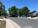 Street view with mature trees lining the street near well-maintained homes at 12252 Elmendorf Pl, Denver, CO 80239