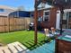 Landscaped backyard featuring artificial grass and outdoor seating with a grill for barbecues and outdoor dining at 1847 W 41St Ave, Denver, CO 80211