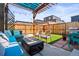 A serene backyard space with a comfortable seating area, lush artificial grass, and privacy fencing at 1847 W 41St Ave, Denver, CO 80211