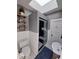 Updated bathroom features a skylight, walk-in shower with glass door, and decorative shelving at 1847 W 41St Ave, Denver, CO 80211