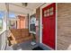 Charming front porch with a classic porch swing and a vibrant red front door, perfect for relaxation at 1847 W 41St Ave, Denver, CO 80211