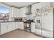 Modern kitchen featuring white cabinets, stainless steel appliances, and ample counter space at 1847 W 41St Ave, Denver, CO 80211