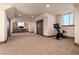 Spacious basement with carpet, a peloton exercise bike, and a work area with dual computer monitors at 2208 Stevens Ct, Castle Rock, CO 80109