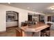 Finished basement featuring a large wet bar with granite countertops, wood cabinets, and stone tile flooring at 2208 Stevens Ct, Castle Rock, CO 80109