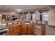 Basement wet bar area with wood cabinets, granite countertop, stainless steel appliances, and recessed lights at 2208 Stevens Ct, Castle Rock, CO 80109