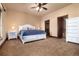 Primary bedroom with a king bed, bedside tables, and a full ensuite bathroom and walk-in closet at 2208 Stevens Ct, Castle Rock, CO 80109