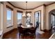 Cozy dining nook with bay windows offers natural light and features a rustic wood table and hardwood floors at 2208 Stevens Ct, Castle Rock, CO 80109