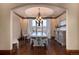 Formal dining room with chandelier, hardwood floors, and large windows overlooking scenic views and modern sideboard at 2208 Stevens Ct, Castle Rock, CO 80109