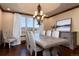Elegant dining room features hardwood floors, a modern chandelier, and a large window framing scenic views at 2208 Stevens Ct, Castle Rock, CO 80109