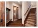 Inviting entryway with wood floors, staircase, and a glimpse of the kitchen through an open doorway at 2208 Stevens Ct, Castle Rock, CO 80109