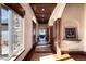 A hallway showcases natural light, wood accents, and a view into the dining room with stone tile accents at 2208 Stevens Ct, Castle Rock, CO 80109