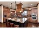 Spacious kitchen features a large granite island with seating, stainless steel appliances, and custom cabinetry at 2208 Stevens Ct, Castle Rock, CO 80109