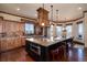 Gourmet kitchen boasts a substantial island, granite countertops, and custom hood vent with stainless appliances at 2208 Stevens Ct, Castle Rock, CO 80109