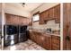 Functional laundry room with modern washer and dryer, granite counters and wooden cabinets at 2208 Stevens Ct, Castle Rock, CO 80109