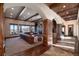 Bright living room with beautiful archways, wood flooring, built-in shelving, and stone fireplace at 2208 Stevens Ct, Castle Rock, CO 80109