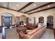 Large living room with wooden trim, stone fireplace, and oversized leather sectional couch at 2208 Stevens Ct, Castle Rock, CO 80109