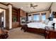 Spacious main bedroom features a fireplace, built-in bookshelves, and large windows with beautiful mountain views at 2208 Stevens Ct, Castle Rock, CO 80109