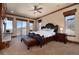Spacious main bedroom suite featuring a luxurious bed, private balcony, and abundant natural light through large windows at 2208 Stevens Ct, Castle Rock, CO 80109