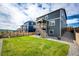 Spacious backyard featuring lush green grass, gravel areas, and a wood fence at 17955 Sky Pilot Ave, Parker, CO 80134