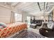 A living area in the basement with a bed, couches, and natural light at 17955 Sky Pilot Ave, Parker, CO 80134