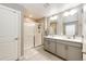 Bright bathroom features a glass door shower, double sink vanity, and tile flooring at 17955 Sky Pilot Ave, Parker, CO 80134