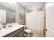 Modern bathroom with grey walls, shower with white curtain and grey vanity at 17955 Sky Pilot Ave, Parker, CO 80134