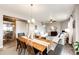 Open dining room with a farmhouse table and a decorative sliding barn door at 17955 Sky Pilot Ave, Parker, CO 80134