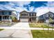 Exterior view of a gray two-story home with red shutters, a two-car garage, and landscaped front yard at 17955 Sky Pilot Ave, Parker, CO 80134