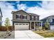 A two-story home with gray siding, red shutters, a two-car garage, and a cozy front porch at 17955 Sky Pilot Ave, Parker, CO 80134