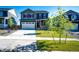 Two-story home with a well-kept lawn, mature trees and a driveway leading to the garage at 17955 Sky Pilot Ave, Parker, CO 80134