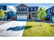 Charming two-story home with a well-manicured lawn and attached two-car garage at 17955 Sky Pilot Ave, Parker, CO 80134