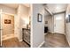 Hallway with hardwood floors, neutral paint, and doorway leading to living spaces at 17955 Sky Pilot Ave, Parker, CO 80134
