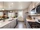 Bright, open kitchen with island, modern appliances, and views of the neighborhood at 17955 Sky Pilot Ave, Parker, CO 80134