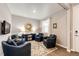 Inviting living room featuring four comfortable armchairs, a round mirror, and a modern design at 17955 Sky Pilot Ave, Parker, CO 80134