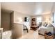 Cozy upstairs living area features a TV, bookshelf and comfortable seating at 17955 Sky Pilot Ave, Parker, CO 80134