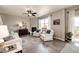 Comfortable living room with fireplace, ceiling fan, and lots of natural light at 17955 Sky Pilot Ave, Parker, CO 80134