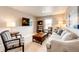 Inviting living space with a TV, comfortable seating, and a bookshelf at 17955 Sky Pilot Ave, Parker, CO 80134