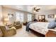 Spacious main bedroom featuring a ceiling fan, sitting area, and lots of natural light at 17955 Sky Pilot Ave, Parker, CO 80134