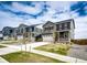 Street view of neighborhood homes with manicured lawns and sidewalks on a sunny day at 17955 Sky Pilot Ave, Parker, CO 80134