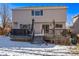 House with backyard, deck, and snowy ground at 1365 Mulberry Ln, Highlands Ranch, CO 80129