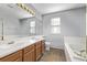 Bathroom boasts double sinks and a large soaking tub at 1365 Mulberry Ln, Highlands Ranch, CO 80129