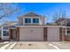 Two-story house with a three-car garage and brick facade at 1365 Mulberry Ln, Highlands Ranch, CO 80129