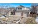 Two-story house with a three-car garage and snow-covered front yard at 1365 Mulberry Ln, Highlands Ranch, CO 80129