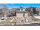 Two-story house with a three-car garage and snow-covered front yard at 1365 Mulberry Ln, Highlands Ranch, CO 80129